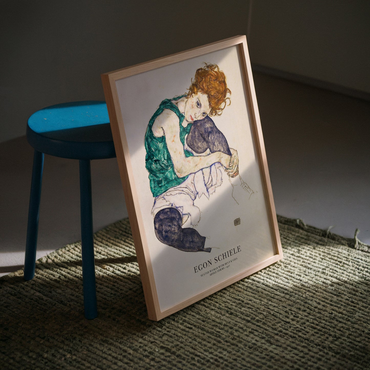 Exhibition poster of Egon Schiele’s Seated Woman with Bent Knees, showcasing a seated woman with vibrant red hair and expressive posture, a striking piece of expressionist art ideal for wall decor and as a thoughtful gift for art collectors.