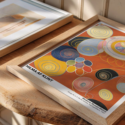 Exhibition poster of Hilma af Klint’s “The Ten Largest No. 7: Adulthood,” featuring bold, circular patterns, spiral motifs, and a warm color palette symbolizing growth and transformation in a modern abstract composition.