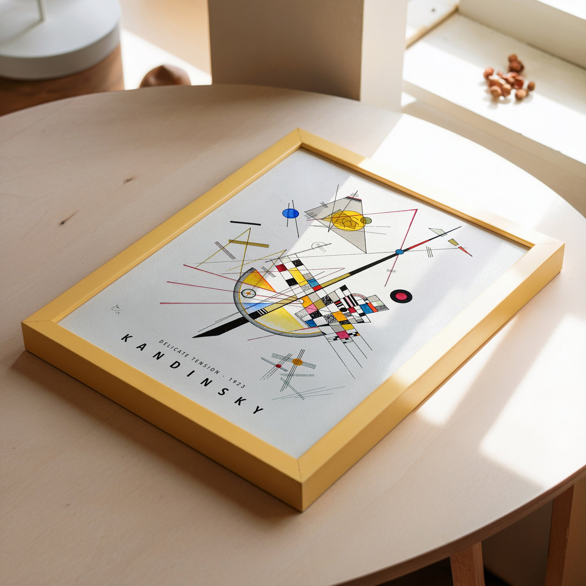 Art print of Wassily Kandinsky’s Delicate Tension from 1923, showcasing a composition of bold geometric shapes and intersecting lines in colors like yellow, red, and blue on a white background.