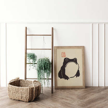 Minimalist frog silhouette art print, bold black lines on a neutral background, perfect for modern and playful decor.