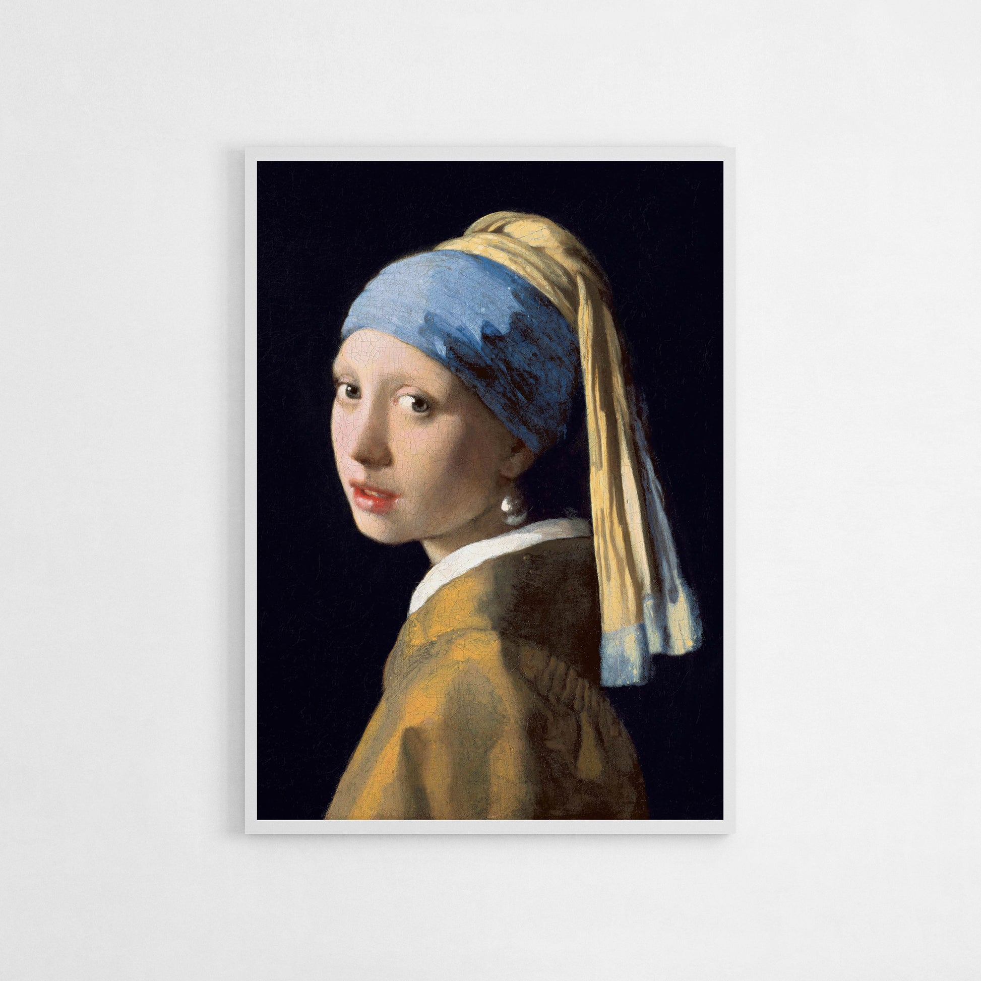 Art print of Johannes Vermeer’s "Girl with a Pearl Earring," featuring a young woman in a blue and gold headscarf with a pearl earring against a dark background.